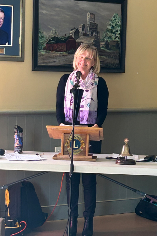 Woman at podium showing Leadership