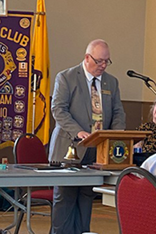 Man at podium showing Leadership